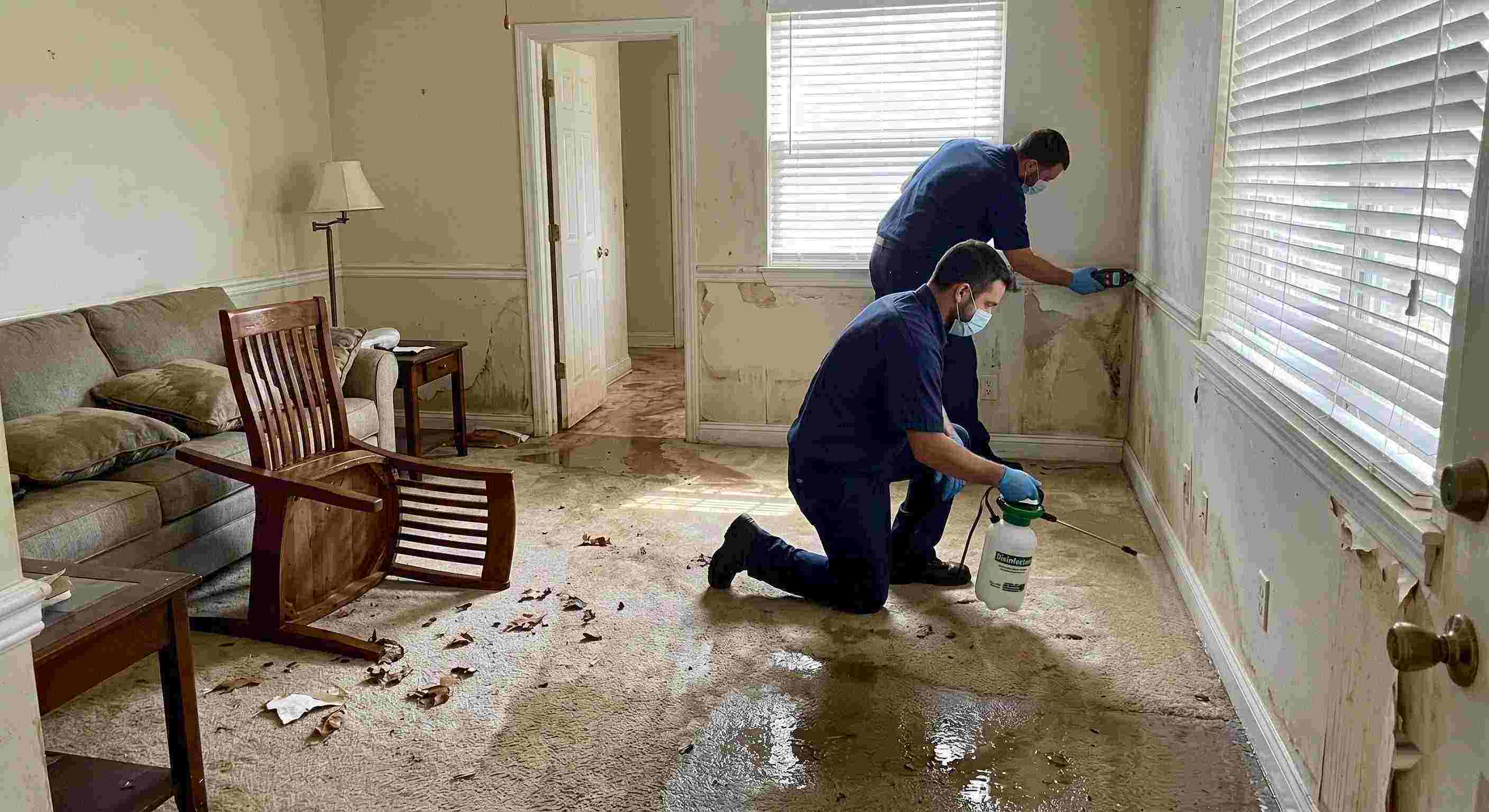 Technicians performing flood disinfection after water damage inside a home in Wichita, ensuring wet floors, damp walls, and household items are sanitized safely.